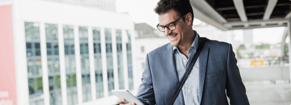 happy-businessman-on-business-trip-looking-at-his-2022-12-16-22-12-30-utc 1